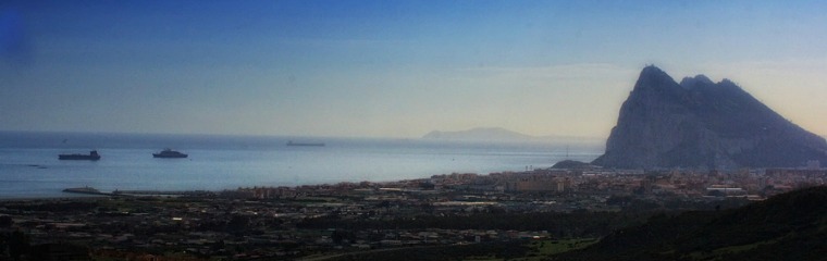 a body of water with a mountain in the background